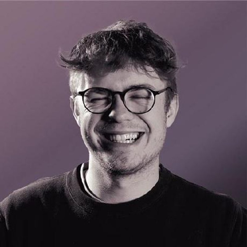 Oscar Beamish: round glasses, dark t-shirt, laughing with his eyes completely shut. It was the best one of the set.