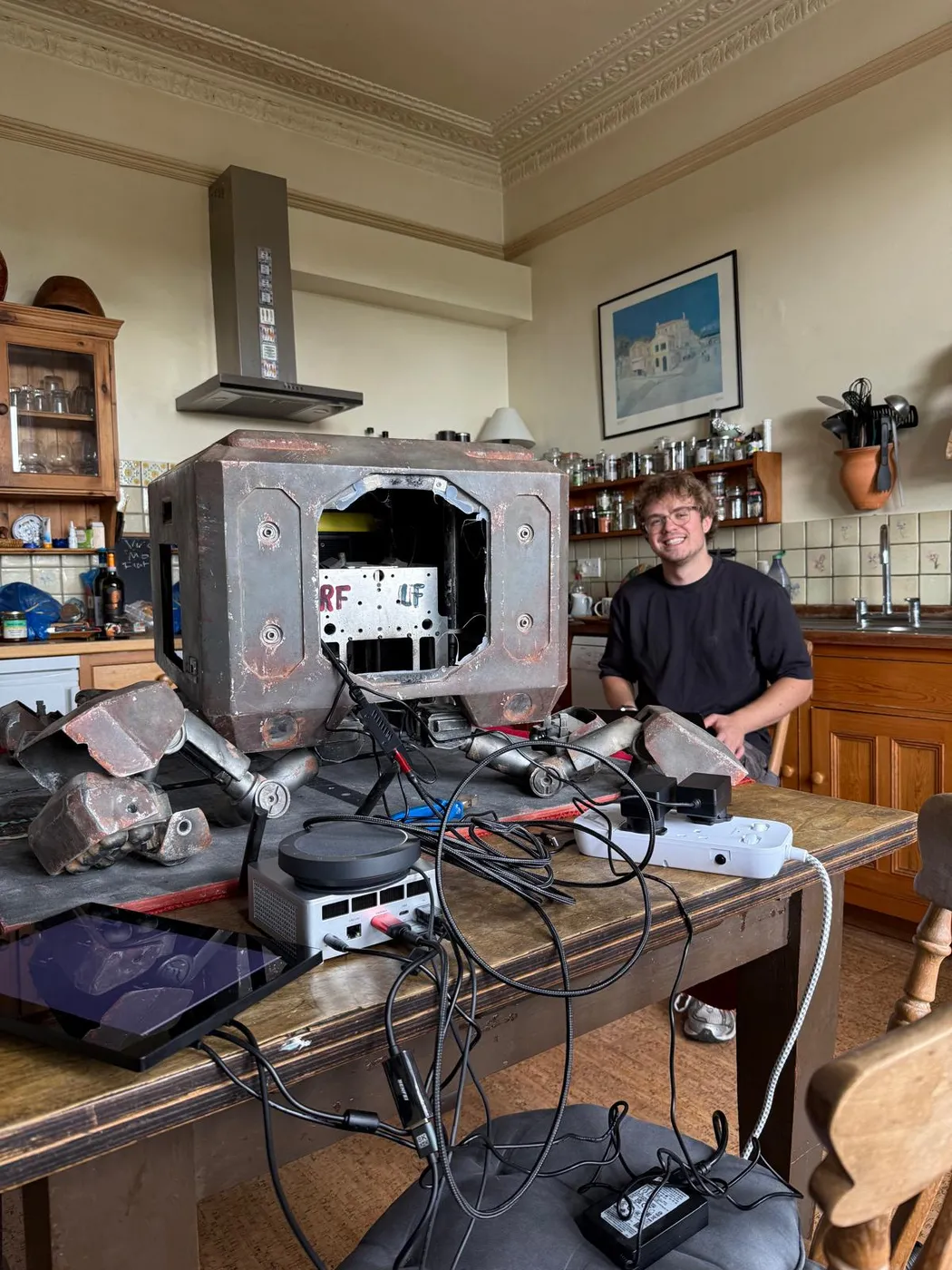 Die Bach in pieces on a kitchen table, with the mini PC, microphone and cabling that go inside him
